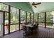 Inviting screened-in porch with an outdoor dining area surrounded by trees at 9 Piney Grove Rd, Bahama, NC 27503