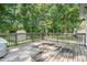 The wooden deck looks out onto a private, green, and lush backyard at 908 Snow Hill Rd, Durham, NC 27712