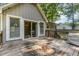 The wooden deck is attached to a light gray house, with lush green trees behind it at 908 Snow Hill Rd, Durham, NC 27712