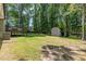 A large backyard and shed provide space and storage at 908 Snow Hill Rd, Durham, NC 27712