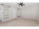 Spacious bedroom with carpeted flooring, ceiling fan, and access to the bathroom at 908 Snow Hill Rd, Durham, NC 27712
