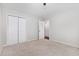 This is a light and airy bedroom, with carpet, closet, and a bright hallway at 908 Snow Hill Rd, Durham, NC 27712