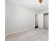 This is a light and airy bedroom, with carpet, closet, and a bright hallway at 908 Snow Hill Rd, Durham, NC 27712