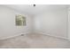 This bedroom is carpeted, featuring a window, and is well-lit with overhead lighting at 908 Snow Hill Rd, Durham, NC 27712