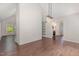 Dining area leading to the kitchen, featuring hardwood floors and white brick accent wall at 908 Snow Hill Rd, Durham, NC 27712