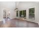 Open dining area featuring hardwood floors, a modern light fixture, and access to the kitchen at 908 Snow Hill Rd, Durham, NC 27712