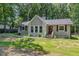 Charming single story home featuring a gray painted brick and siding exterior with a mature landscaped yard at 908 Snow Hill Rd, Durham, NC 27712
