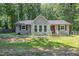 Charming single story home featuring a gray painted brick and siding exterior with a mature landscaped yard at 908 Snow Hill Rd, Durham, NC 27712