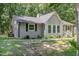 Charming single story home featuring a gray painted brick and siding exterior with a mature landscaped yard at 908 Snow Hill Rd, Durham, NC 27712
