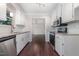 Bright kitchen with stainless steel appliances, white cabinets, and granite countertops at 908 Snow Hill Rd, Durham, NC 27712