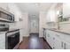 Well-lit kitchen with stainless steel appliances, white cabinets, and granite countertops at 908 Snow Hill Rd, Durham, NC 27712