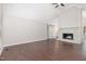 Spacious living room featuring hardwood floors, vaulted ceilings, a brick fireplace, and a sliding barn door at 908 Snow Hill Rd, Durham, NC 27712