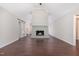 Spacious living room featuring hardwood floors, vaulted ceilings, a brick fireplace, and a sliding barn door at 908 Snow Hill Rd, Durham, NC 27712