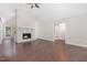 Spacious living room with a vaulted ceiling, wood floors, a fireplace, and modern ceiling fan at 908 Snow Hill Rd, Durham, NC 27712