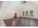 Open concept living room with hardwood floors, vaulted ceilings, a red front door, and large windows at 908 Snow Hill Rd, Durham, NC 27712