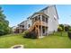Back of house featuring a screened porch and a fire pit in a manicured lawn at 908 Woodland Grove Way, Wake Forest, NC 27587