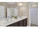 Bright bathroom with a double vanity, large mirrors, and a shower behind a closed door at 908 Woodland Grove Way, Wake Forest, NC 27587