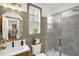 Bathroom featuring a glass shower, wooden vanity with a modern sink, and window providing natural light at 908 Woodland Grove Way, Wake Forest, NC 27587