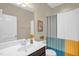 Bright bathroom features a single vanity and a shower with a colorful curtain at 908 Woodland Grove Way, Wake Forest, NC 27587