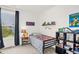 Comfortable bedroom with a twin bed, a window, and decorative shelves filled with toys at 908 Woodland Grove Way, Wake Forest, NC 27587