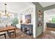 Elegant dining room with stylish wallpaper, hardwood floors, a modern light fixture, and sophisticated decor at 908 Woodland Grove Way, Wake Forest, NC 27587