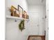 Charming hallway decorated with artwork, a wreath, and coat hooks, enhancing the cozy atmosphere at 908 Woodland Grove Way, Wake Forest, NC 27587