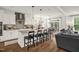 Modern kitchen with white cabinets, a stylish backsplash, stainless steel appliances, and an island with bar seating at 908 Woodland Grove Way, Wake Forest, NC 27587