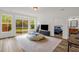 Bright living room with a large window that offers a view of the backyard and natural light at 908 Woodland Grove Way, Wake Forest, NC 27587
