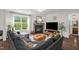 Bright living room with a fireplace, large window, comfortable seating, and stylish decor, perfect for relaxation at 908 Woodland Grove Way, Wake Forest, NC 27587
