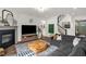 Cozy living room featuring a fireplace, comfortable seating, hardwood floors, and a staircase, creating an inviting atmosphere at 908 Woodland Grove Way, Wake Forest, NC 27587