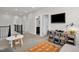 Upstairs loft area with TV and shelving, perfect for , with neutral carpet and a view of a bathroom at 908 Woodland Grove Way, Wake Forest, NC 27587