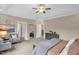 Large main bedroom with seating area, neutral colors, tray ceilings, and large mirror at 908 Woodland Grove Way, Wake Forest, NC 27587