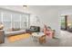 Bright playroom featuring a sofa, daybed, table, chairs, play kitchen, and large windows at 908 Woodland Grove Way, Wake Forest, NC 27587