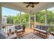 Relaxing screened-in porch with cozy seating and a view of the treeline at 908 Woodland Grove Way, Wake Forest, NC 27587