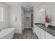 Bathroom featuring double sink vanity, walk-in shower, a free standing tub, and wooden floors at 909 Green Oaks Pkwy, Holly Springs, NC 27540