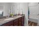 Bathroom boasts double granite vanity, two sinks, granite counters, and walk-in shower at 909 Green Oaks Pkwy, Holly Springs, NC 27540