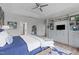 Bright bedroom boasts gray built-ins, drawers, shelves, tv, hard wood floors, and modern decor at 909 Green Oaks Pkwy, Holly Springs, NC 27540