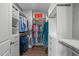 Spacious walk-in closet with built-in shelving, hanging rods, drawers, and wood flooring at 909 Green Oaks Pkwy, Holly Springs, NC 27540