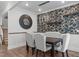 Elegant dining room featuring a square table, cushioned chairs, and a decorative accent wall at 909 Green Oaks Pkwy, Holly Springs, NC 27540