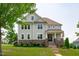 Charming two-story home with stone accents, manicured lawn, and inviting front porch at 909 Green Oaks Pkwy, Holly Springs, NC 27540