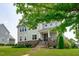 Charming two-story home with stone accents, manicured lawn, and inviting front porch at 909 Green Oaks Pkwy, Holly Springs, NC 27540