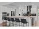 Open kitchen layout featuring an island with bar stools, modern backsplash, and appliances at 909 Green Oaks Pkwy, Holly Springs, NC 27540