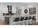 Kitchen island with barstool seating, granite countertops, and modern fixtures at 909 Green Oaks Pkwy, Holly Springs, NC 27540