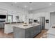 Spacious kitchen featuring an island with a sink, stainless steel appliances, and light colored cabinets at 909 Green Oaks Pkwy, Holly Springs, NC 27540