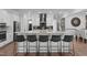 Modern kitchen featuring a central island with barstool seating and stainless steel appliances at 909 Green Oaks Pkwy, Holly Springs, NC 27540