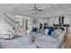 Bright and open living room with views to kitchen, hardwood floors, and comfortable seating at 909 Green Oaks Pkwy, Holly Springs, NC 27540