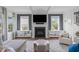 Bright and airy living room with a fireplace, large windows, and a comfortable seating area at 909 Green Oaks Pkwy, Holly Springs, NC 27540