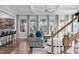 Cozy living room with hardwood floors, large windows, coffered ceiling, and comfortable gray sofas at 909 Green Oaks Pkwy, Holly Springs, NC 27540