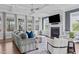 Comfortable living room with coffered ceiling, fireplace, and windows with natural light at 909 Green Oaks Pkwy, Holly Springs, NC 27540