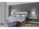 Serene primary bedroom featuring a decorative accent wall, plush bedding, and stylish nightstands at 909 Green Oaks Pkwy, Holly Springs, NC 27540